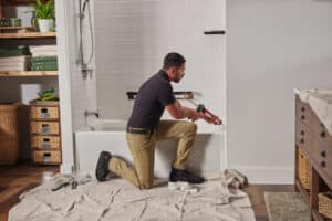 Worker installation add bathtub renovation ideas to a bathroom