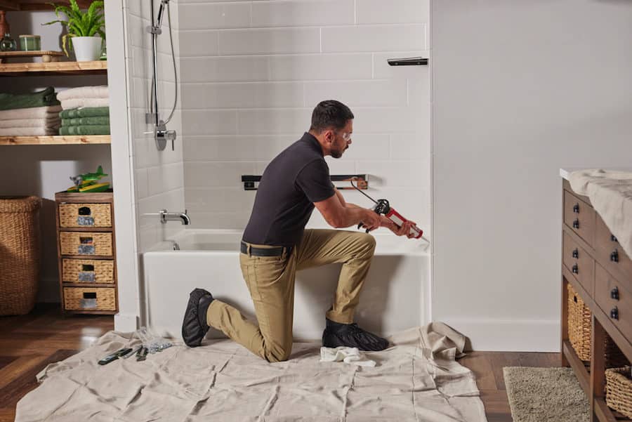 Worker installation add bathtub renovation ideas to a bathroom